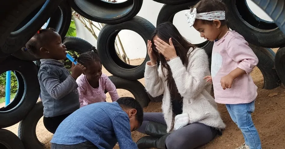 Teacher playing with children at The Little Nest, Arusha Tanzania